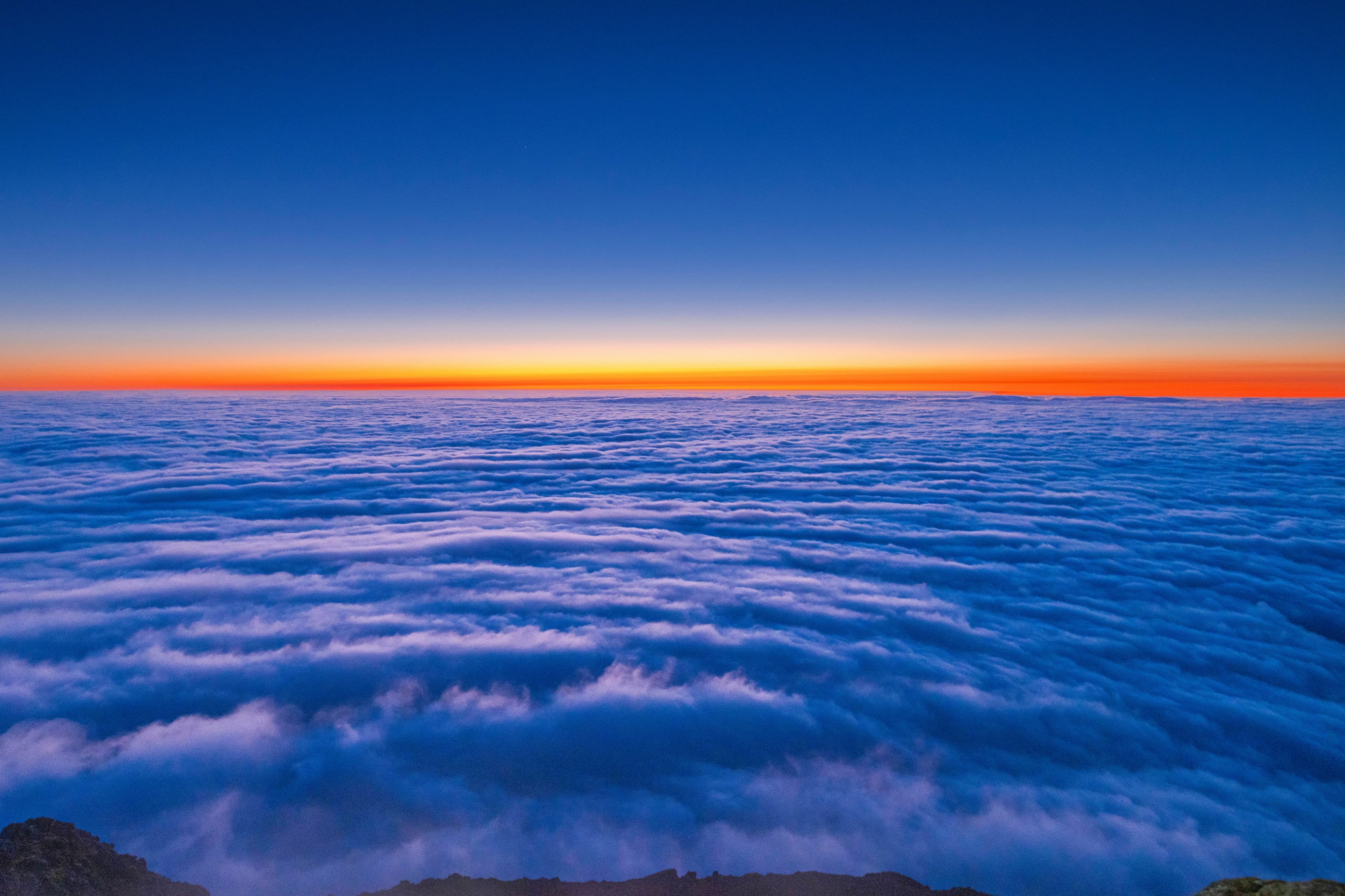 A sea of clouds at sunset seen from above